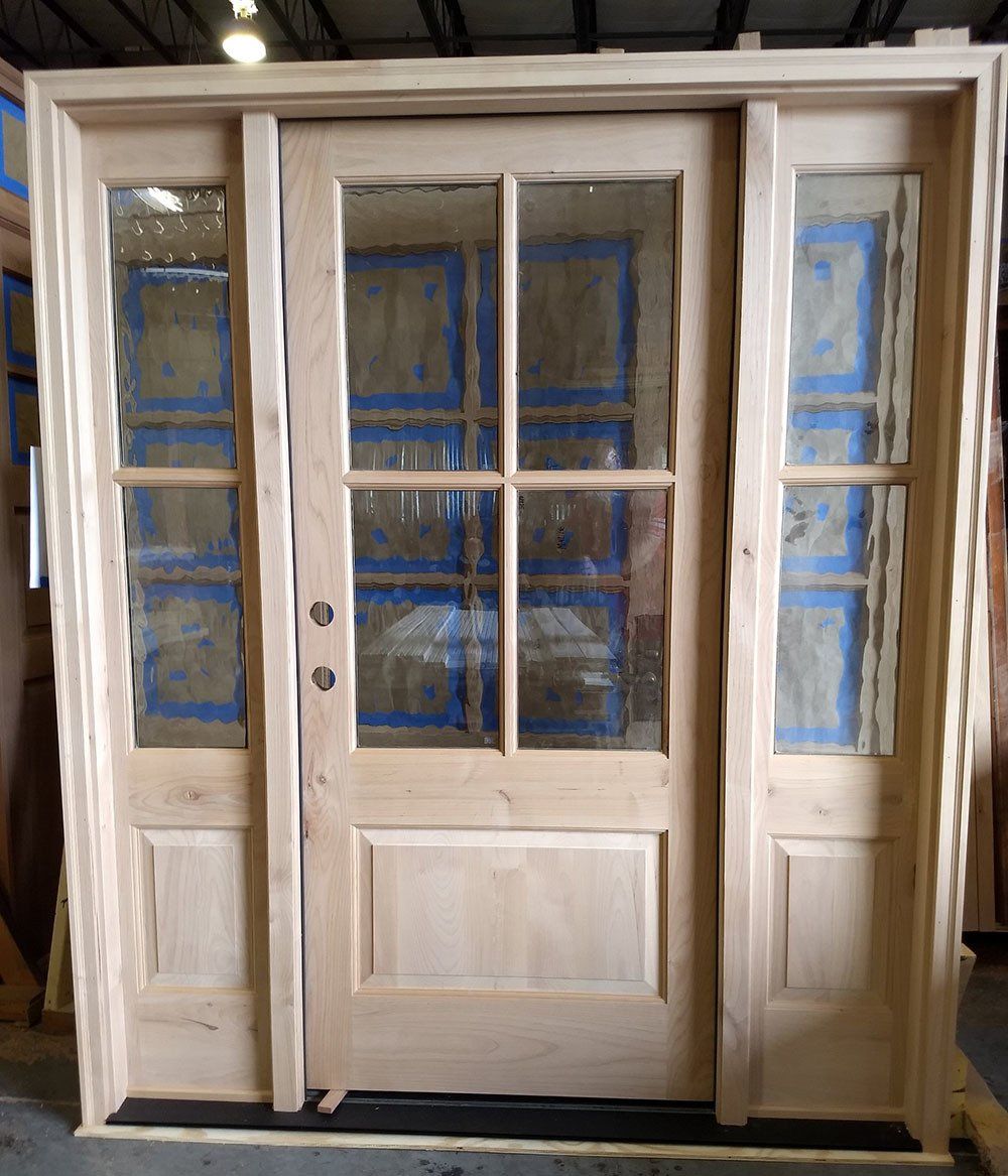 Alder wood door with 4 panes of glass over solid panel and matching sidelites