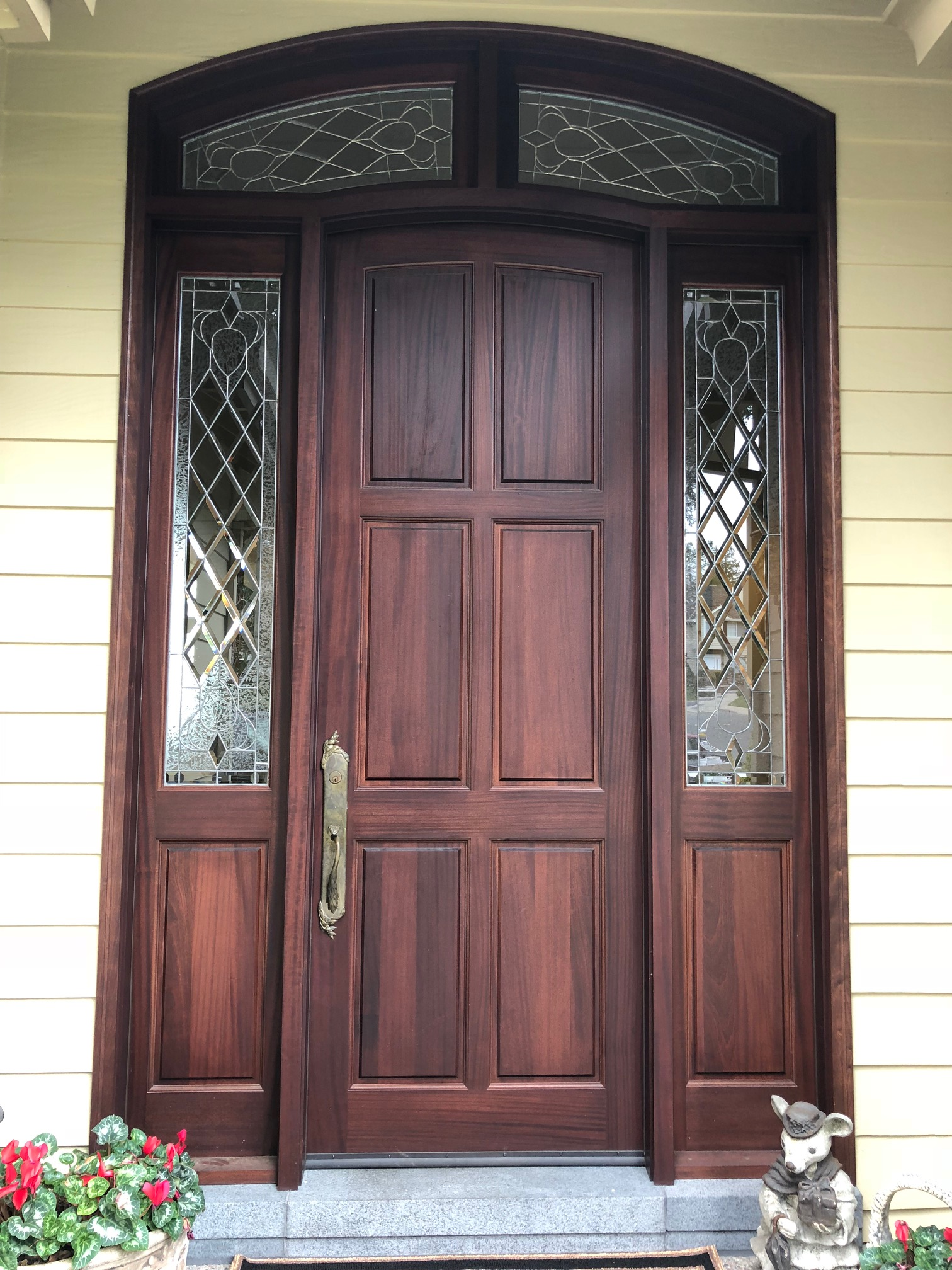 6 panel door with sidelights and arch top transom.