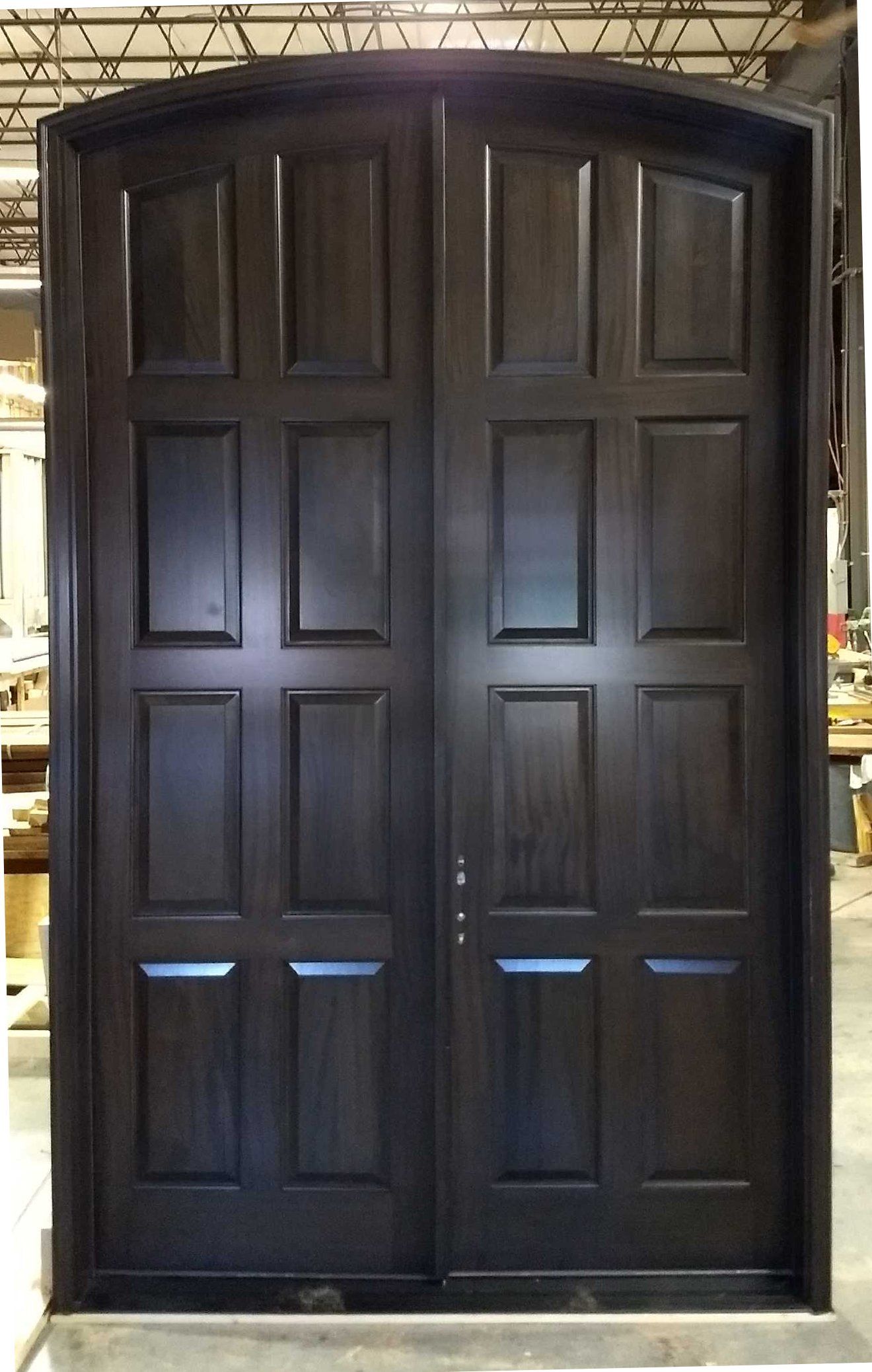 A large wooden door is sitting in a warehouse