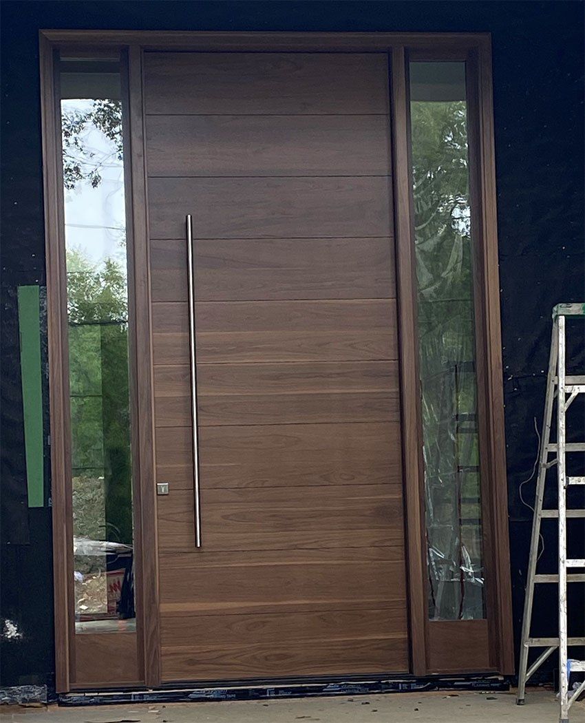 A large wooden door with a ladder in front of it.