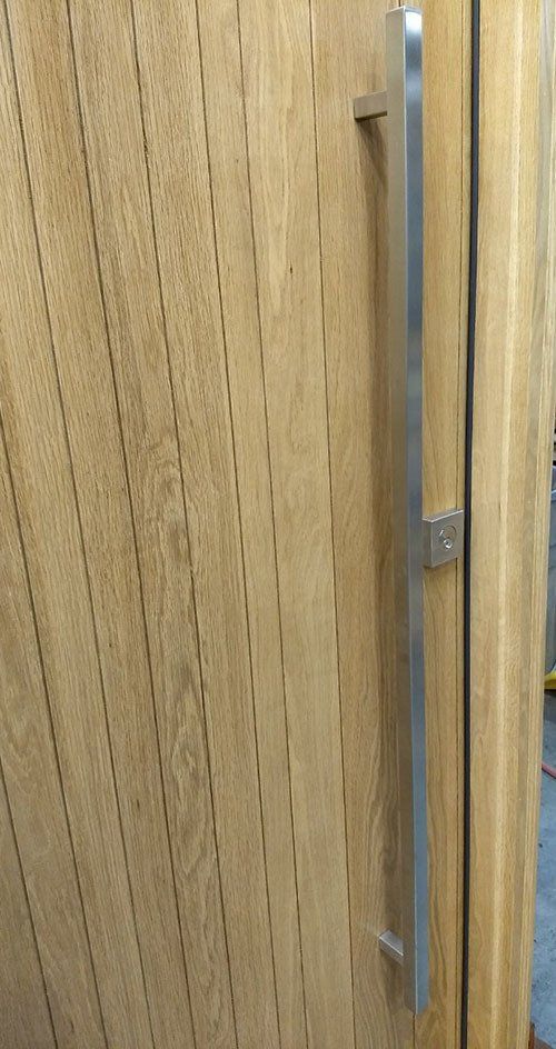 White Oak modern front door with stainless steel hardware