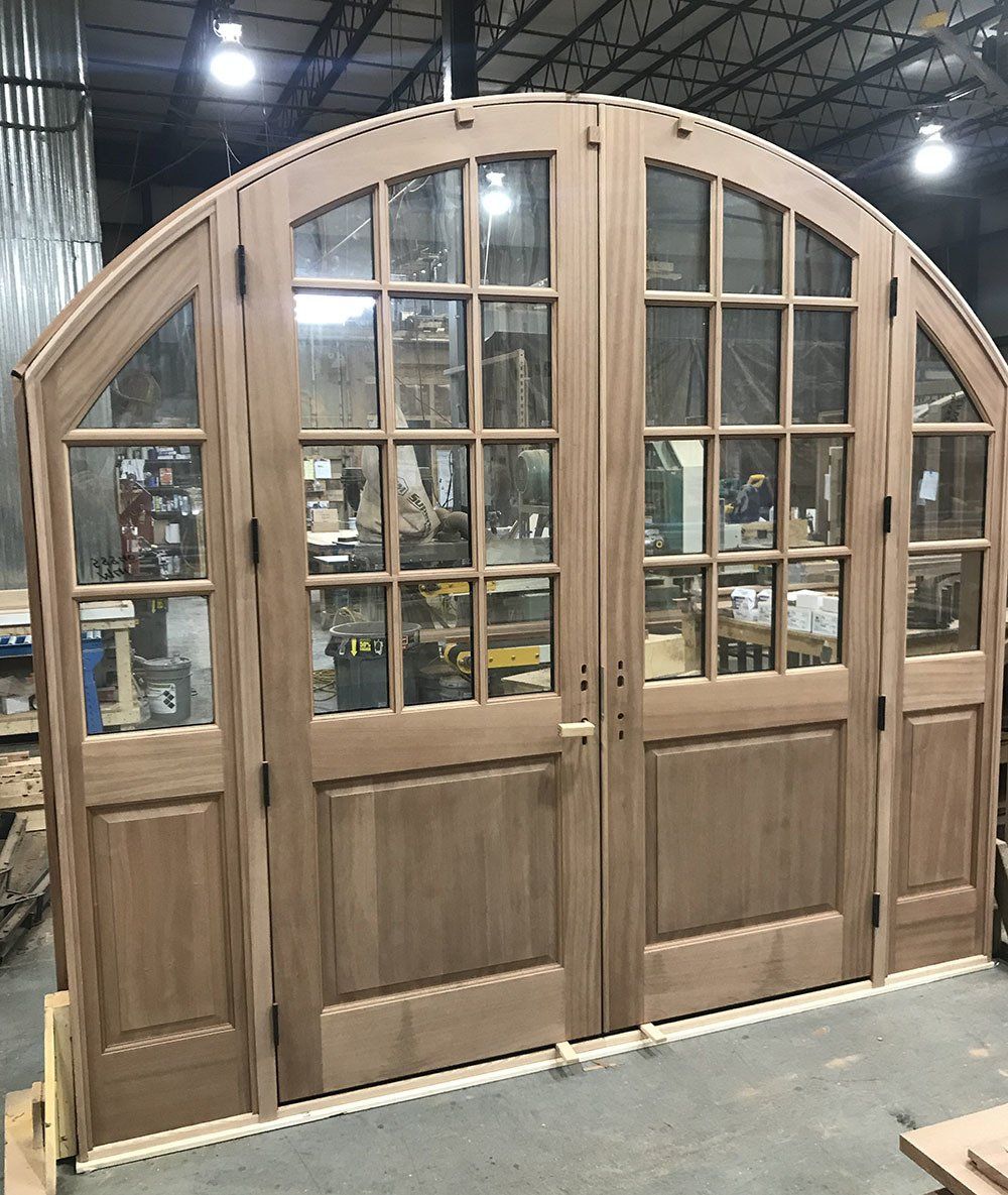 Giant arched double entry door with sidelights made from Sapele mahogany