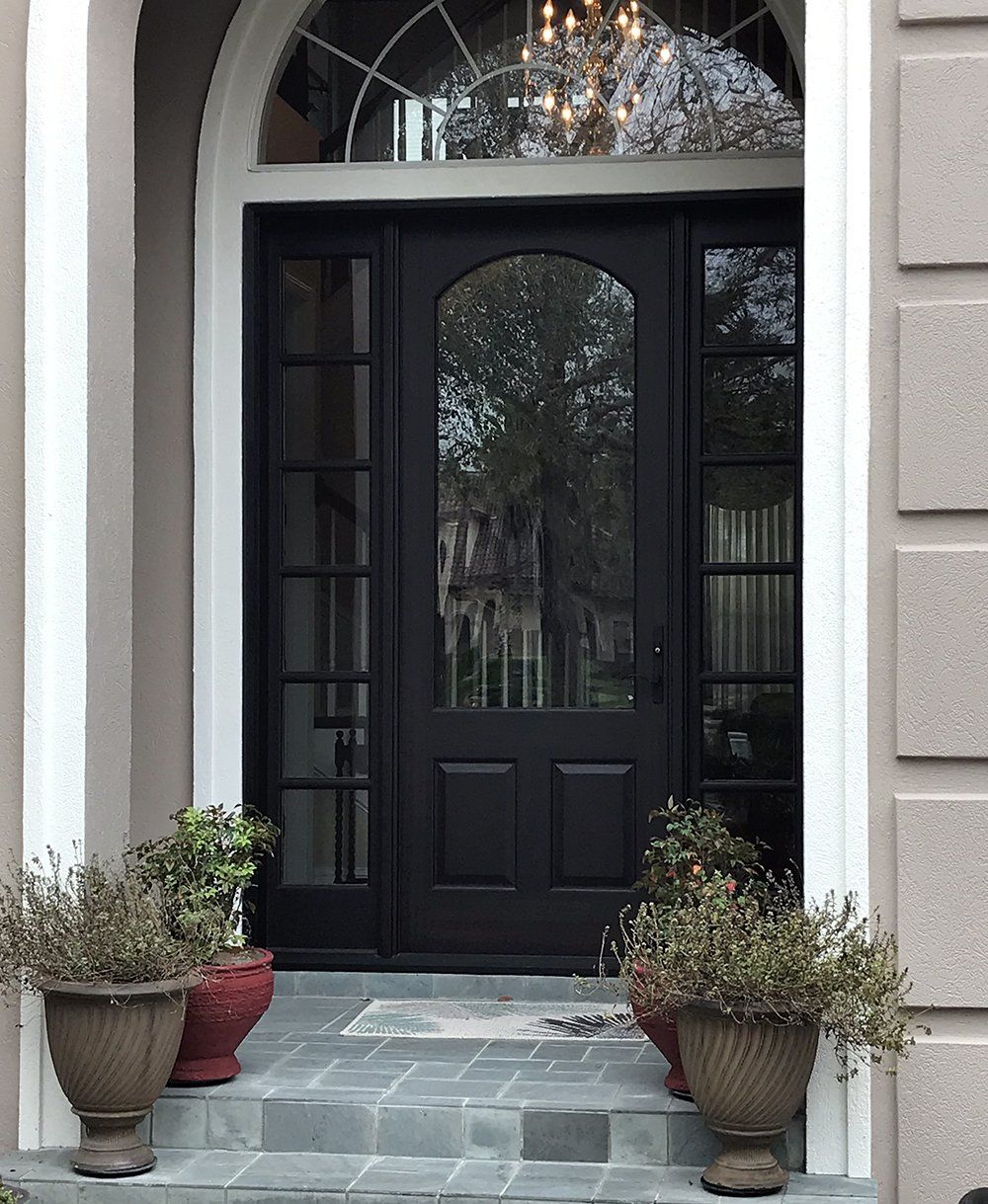 Nothing welcomes like a hand crafted mahogany front door with sidelites