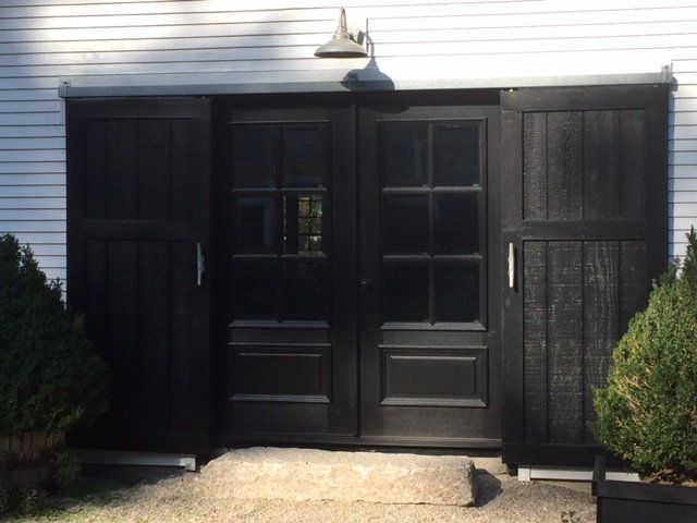 A white house with a black garage door