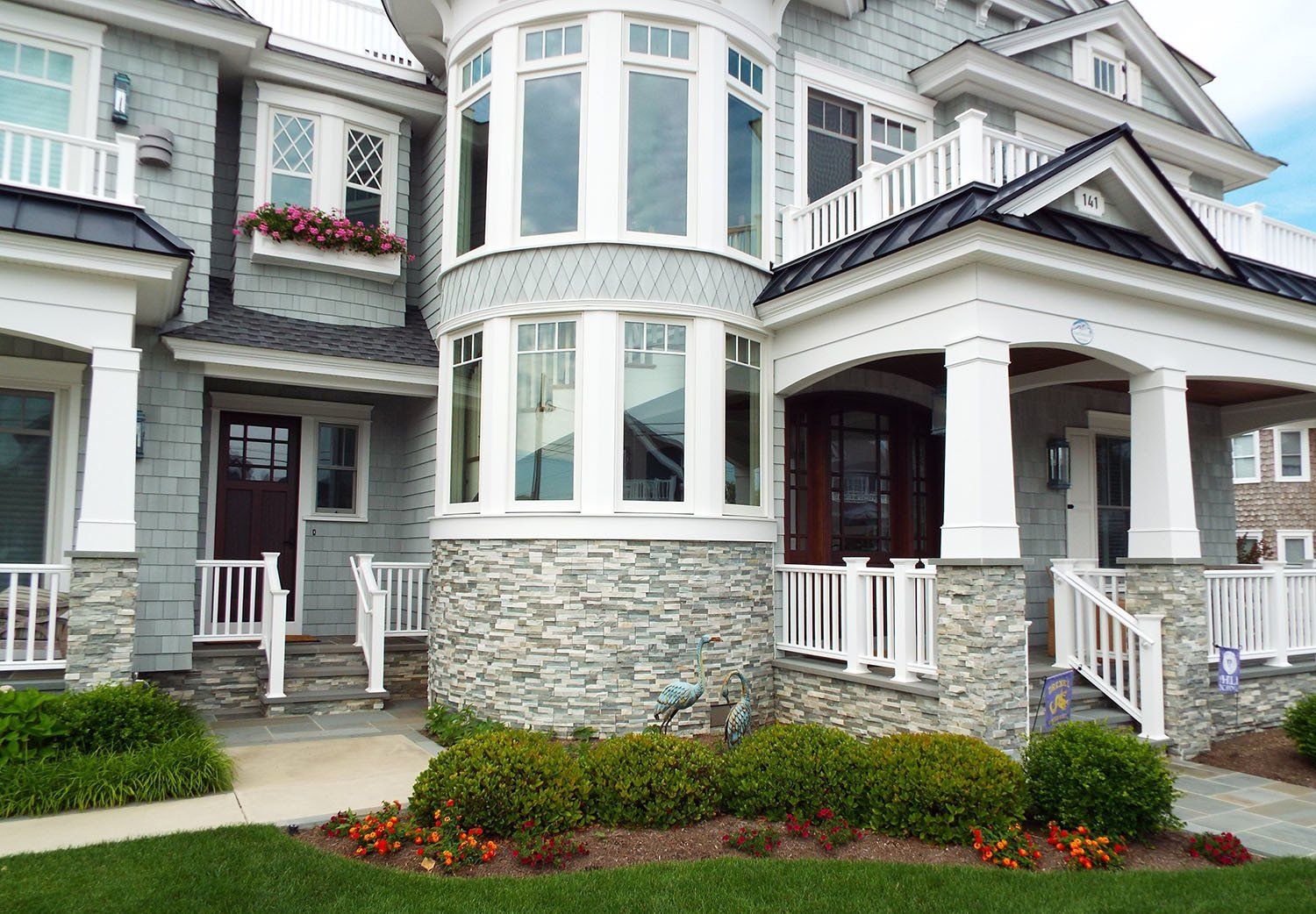 A large house with a lot of windows and a porch