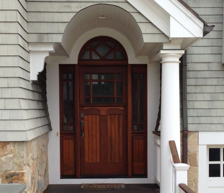 The front door of a house has a welcome mat on it