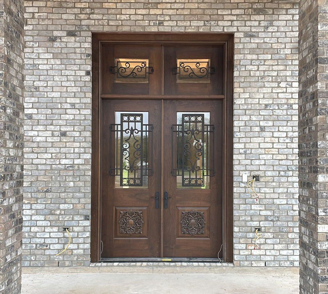 A brick building with a wooden double door