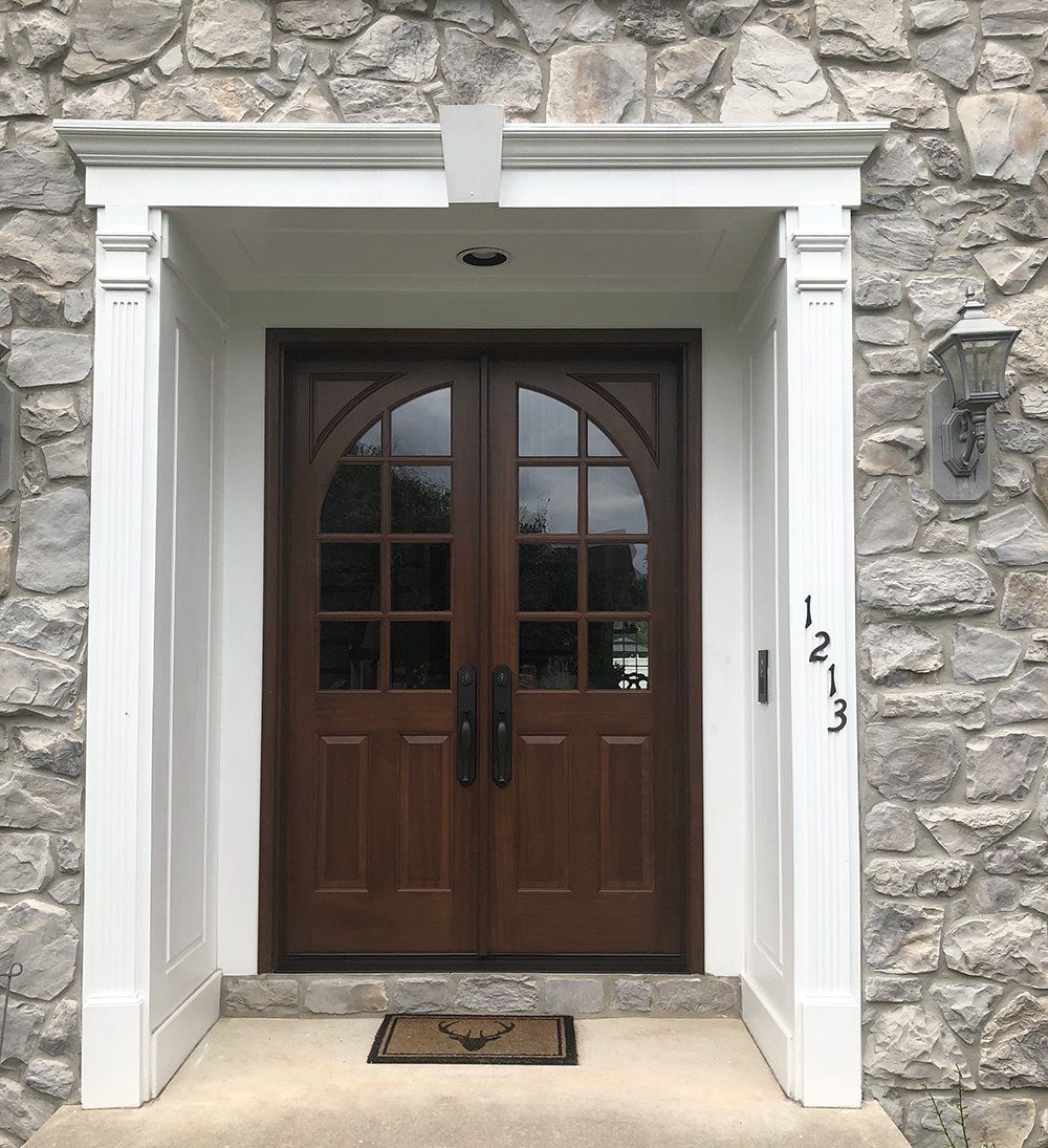 The front door of a stone house with a wooden door
