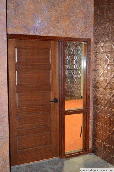 A wooden door with a window in a room