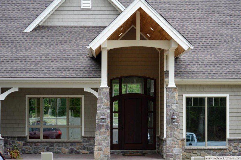A house with a porch and a gray roof