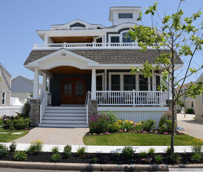 A large house with a large porch and stairs