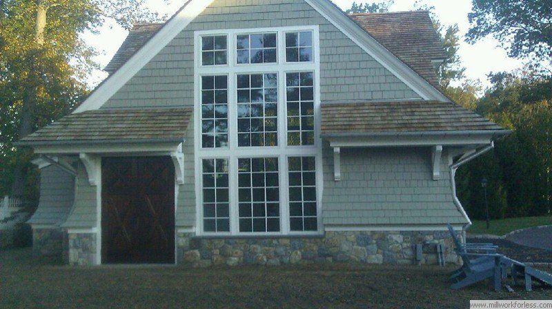 A small house with a lot of windows and a wooden door
