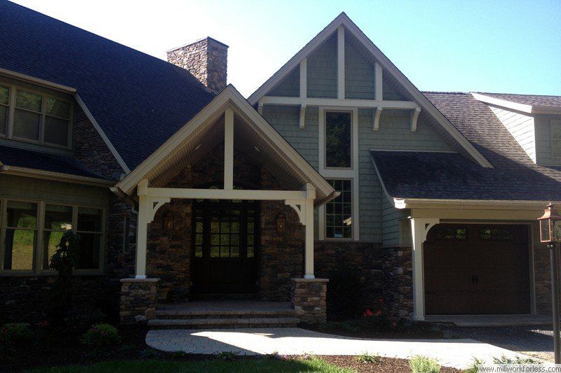 A large house with a porch and a garage