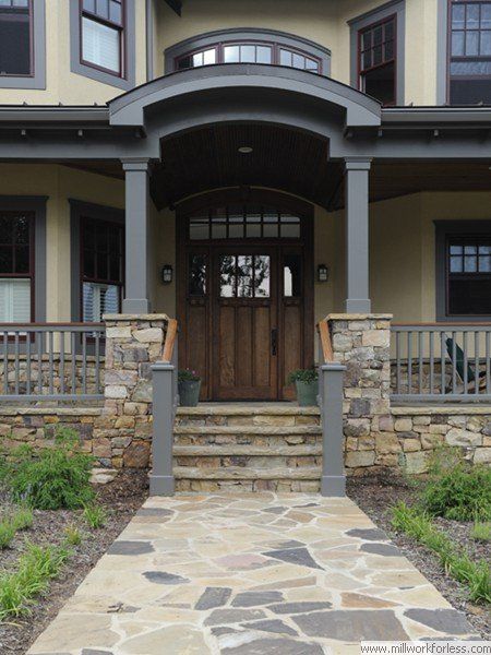 A stone walkway leads to the front door of a house