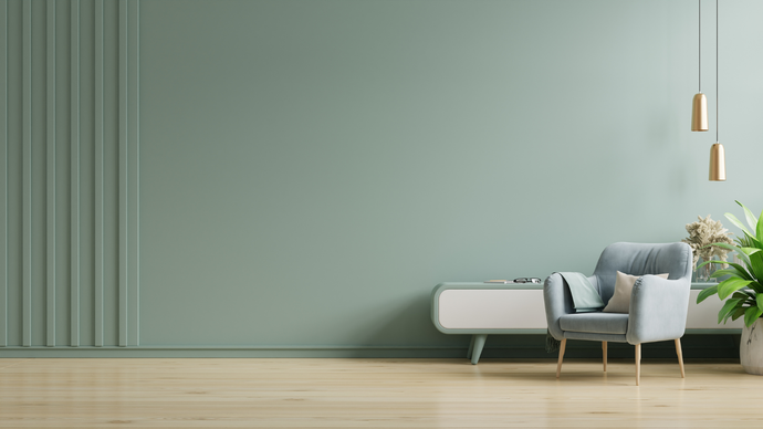 A living room with a chair , dresser , and a green wall.
