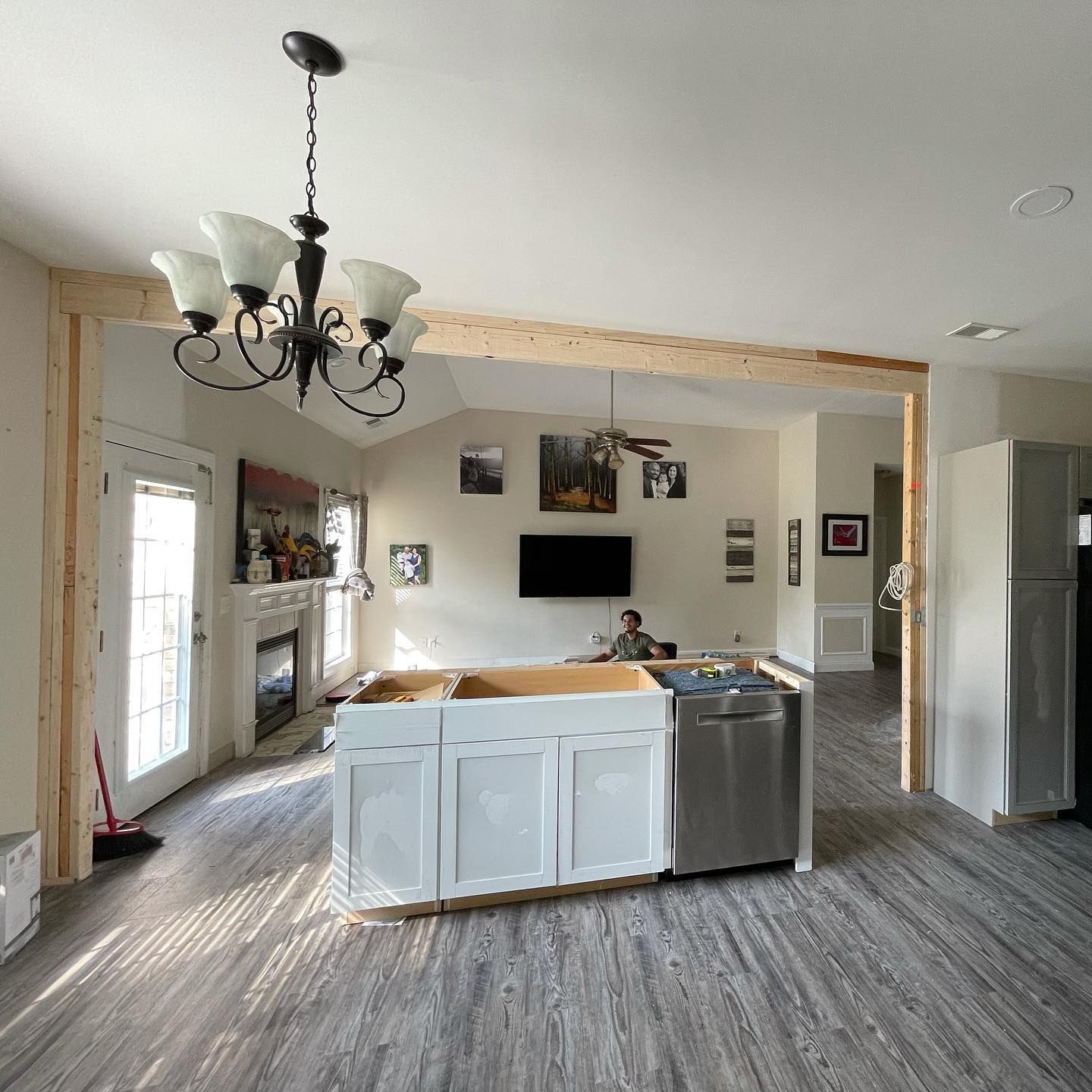 A kitchen with white cabinets and a stainless steel dishwasher
