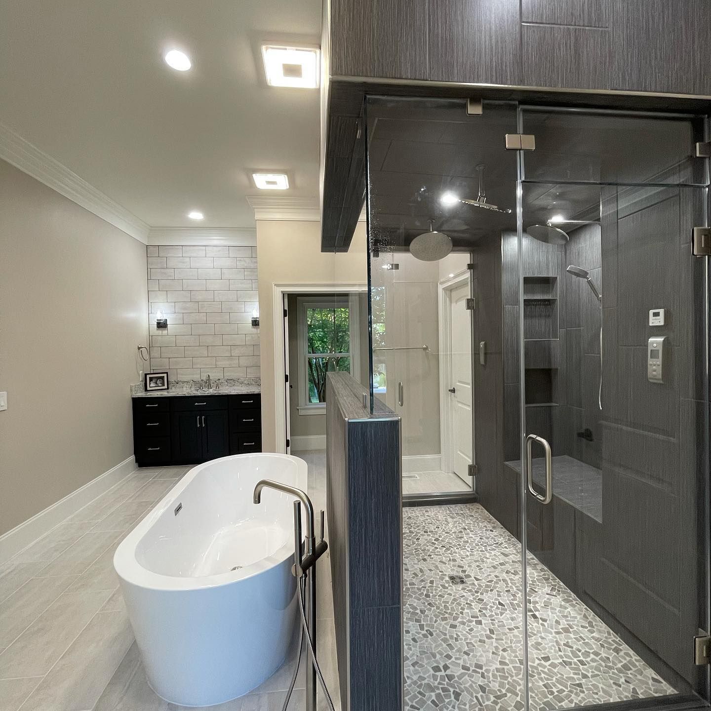 A bathroom with a bathtub and a walk in shower