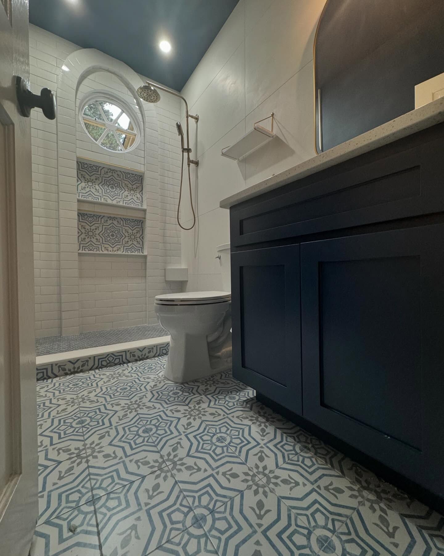 A bathroom with a toilet , sink , and shower.