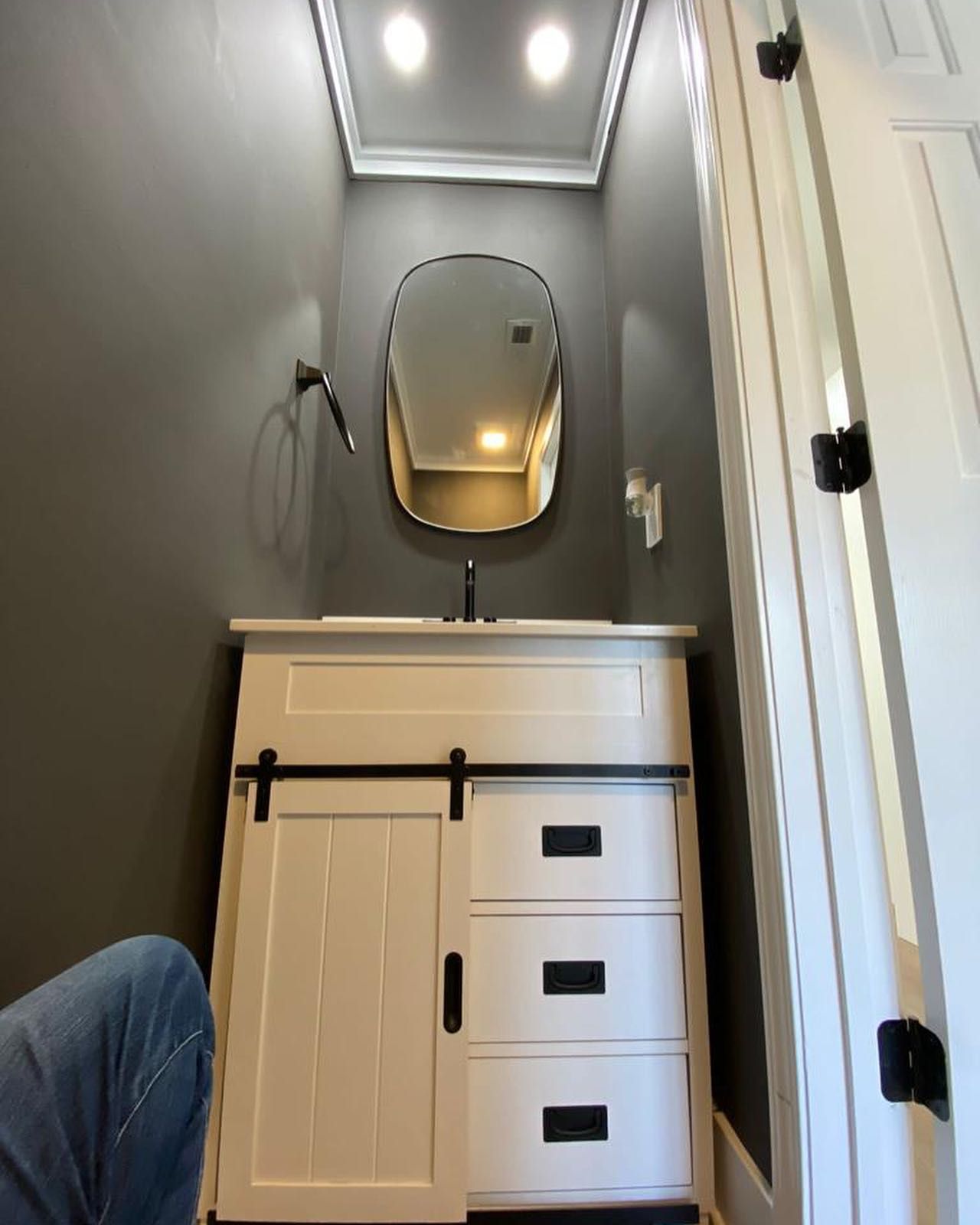 A bathroom with a sink and a mirror on the wall