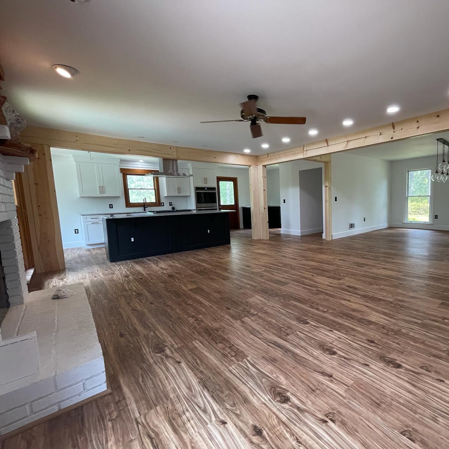 A living room with hardwood floors and a ceiling fan.