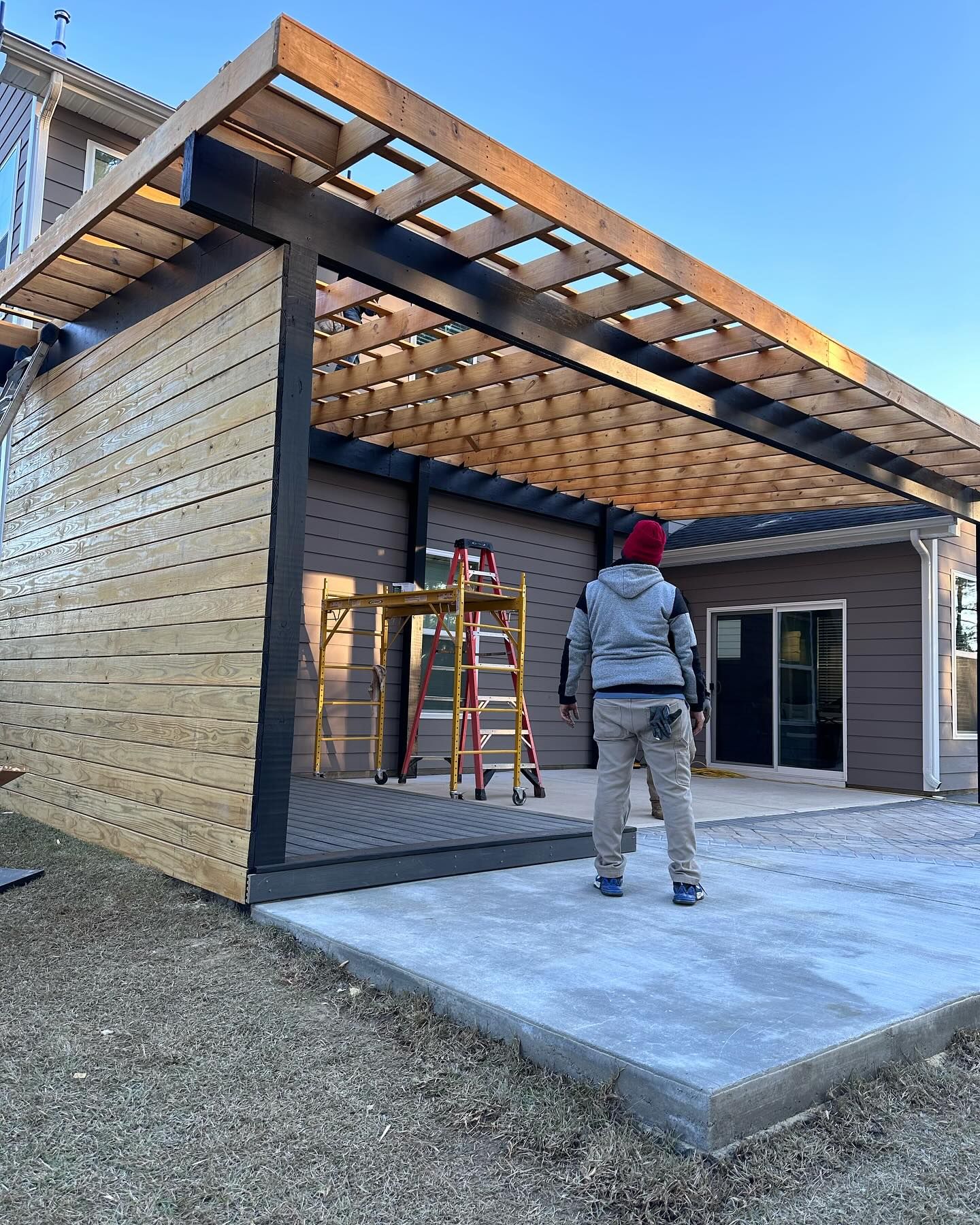 A man is standing in front of a building under construction.