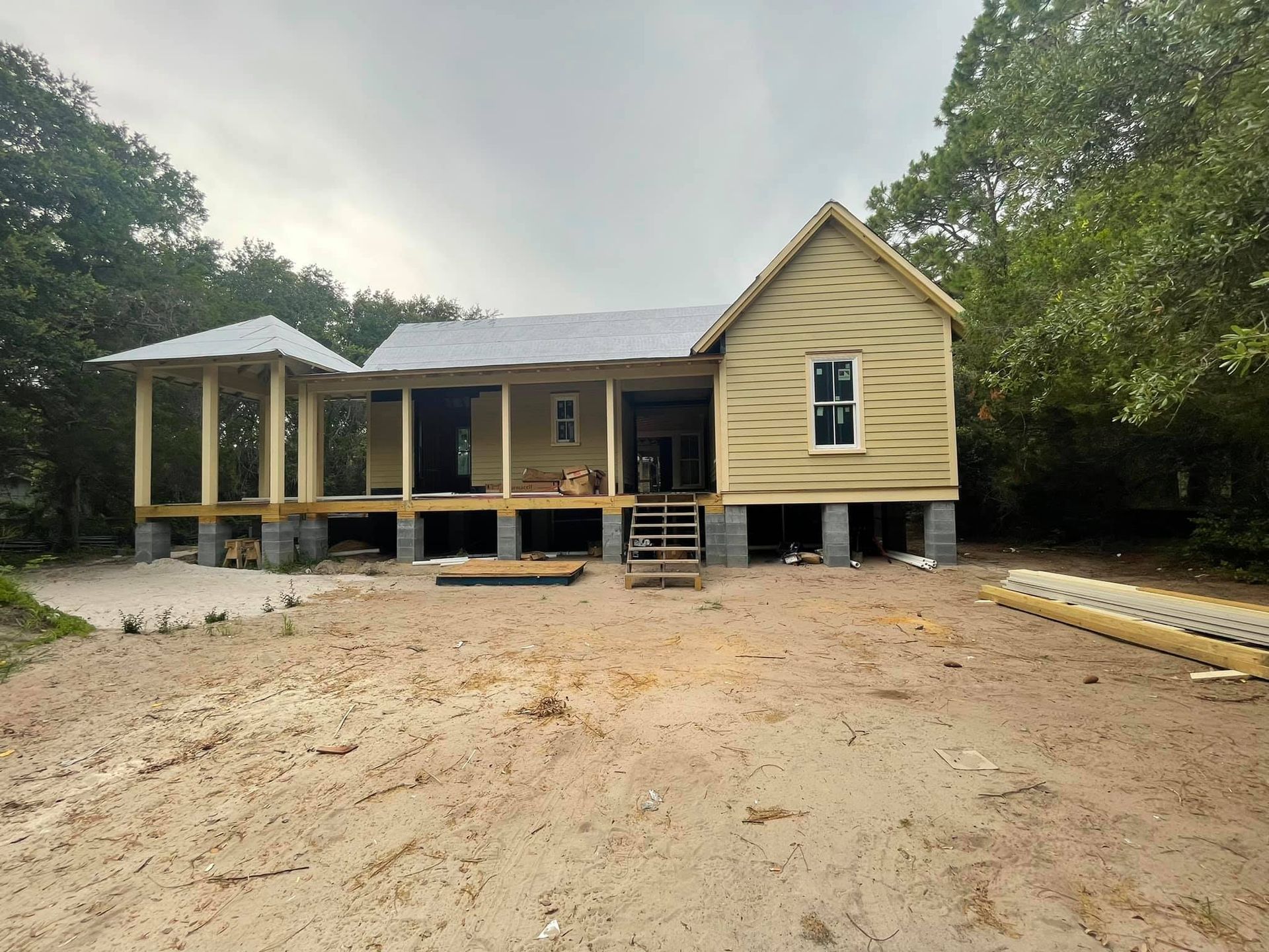 A house is being built in the middle of a dirt field