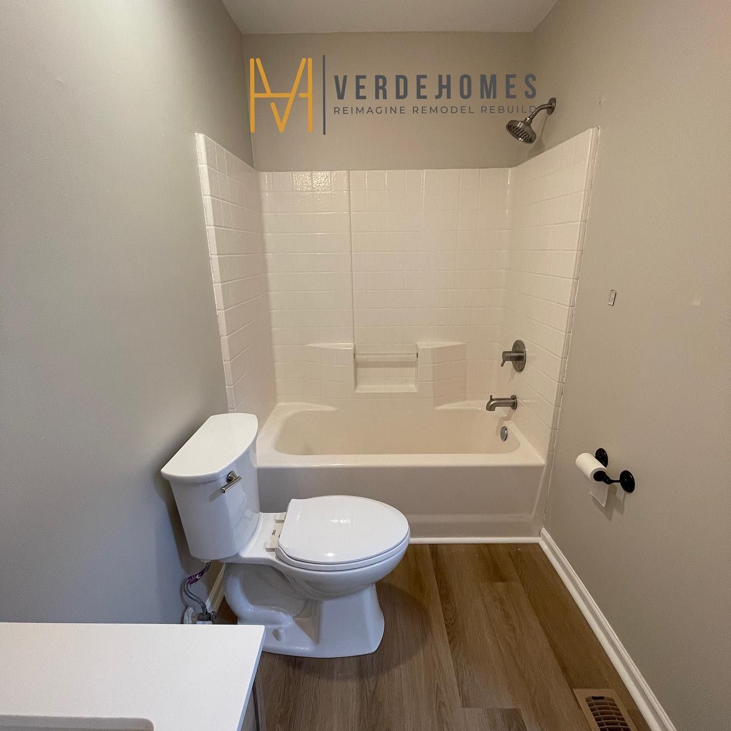 A bathroom with a toilet , sink , bathtub and shower.