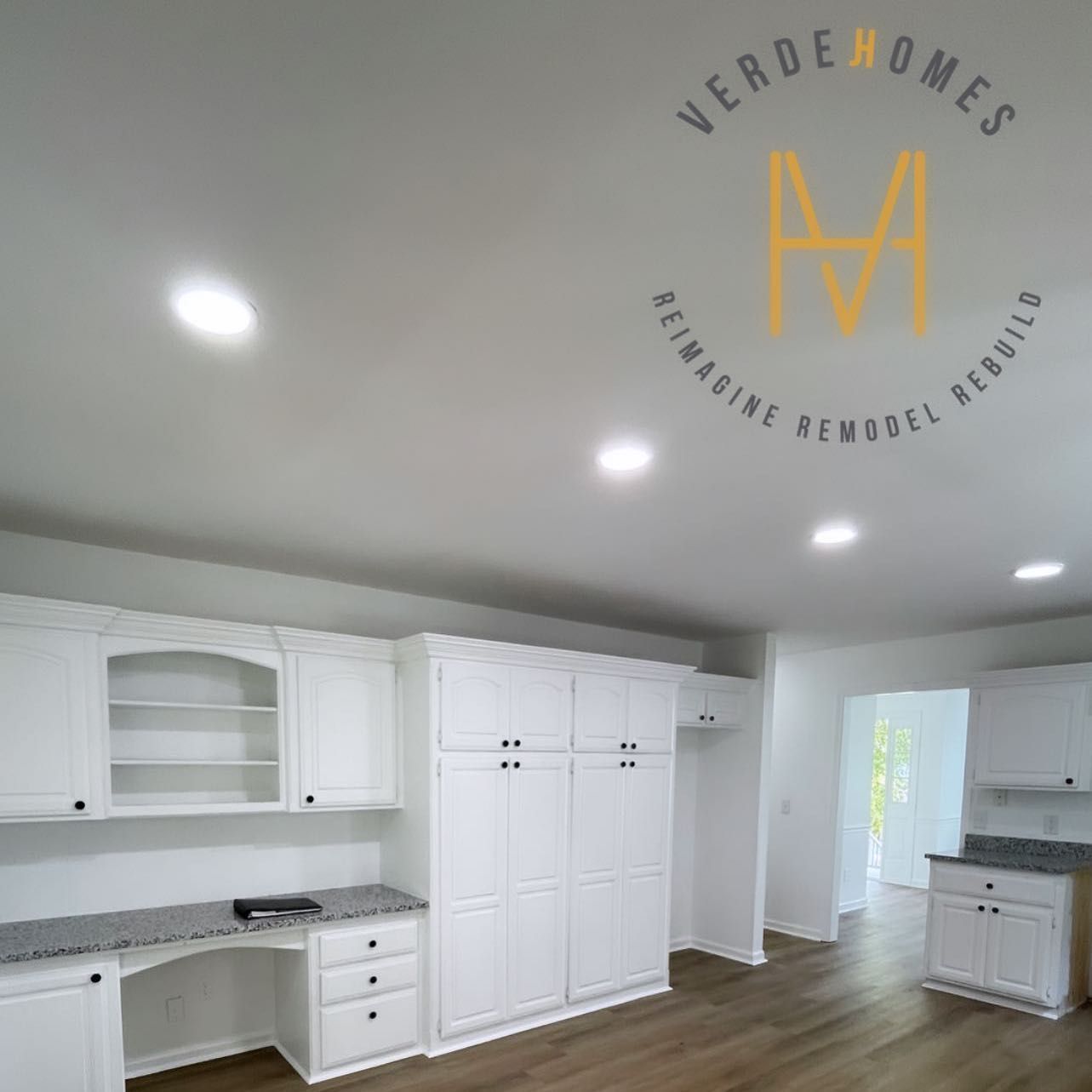 A room with white cabinets and a logo that says verde homes