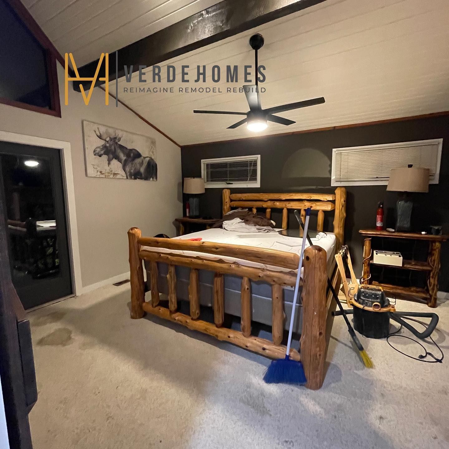 A bedroom with a log bed and a ceiling fan