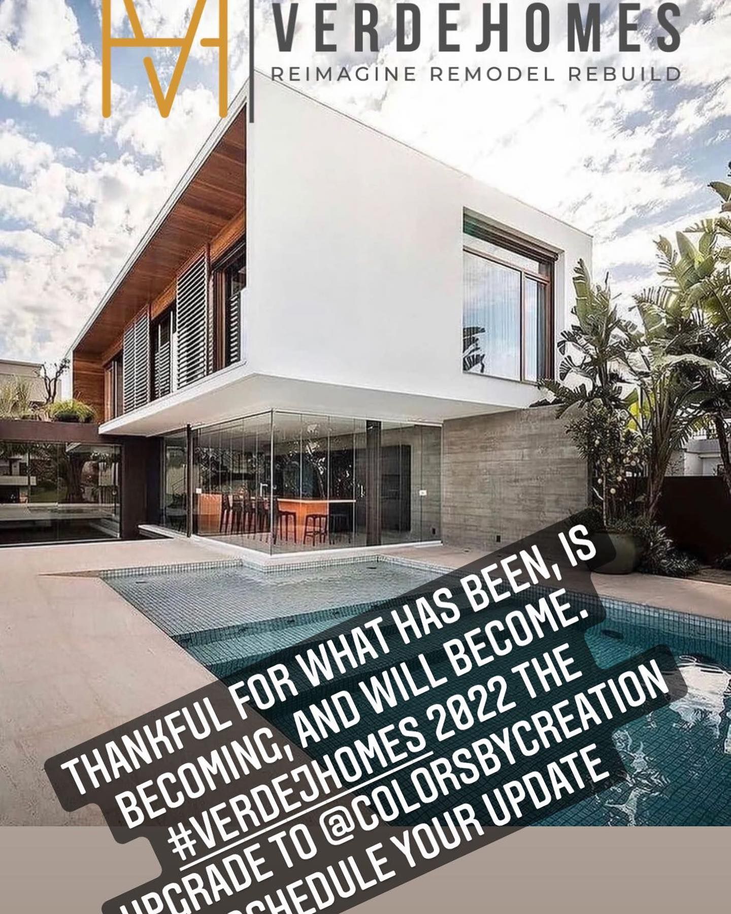 A large white house with a pool in front of it.