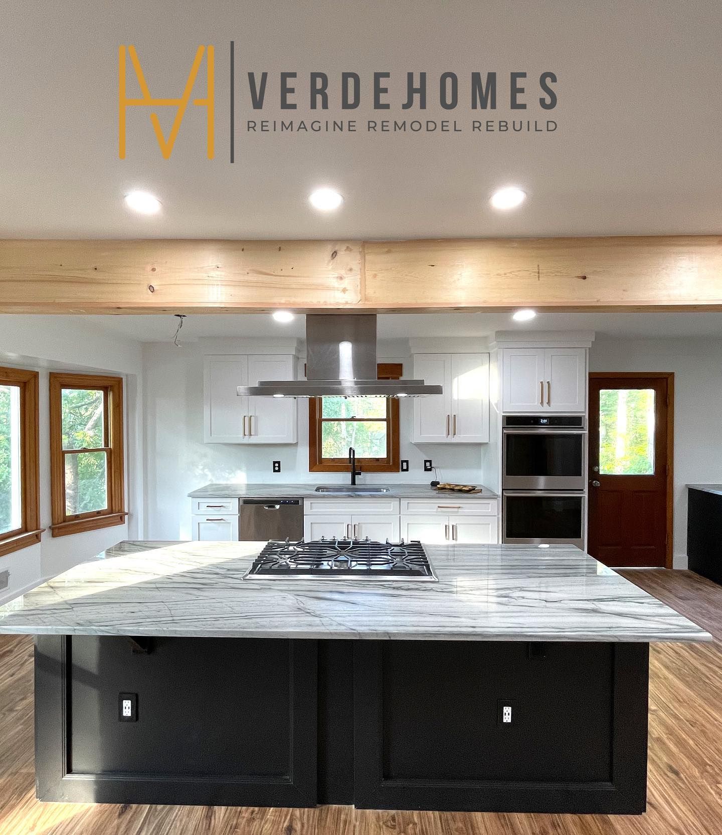 A kitchen with a large island and a stove top oven