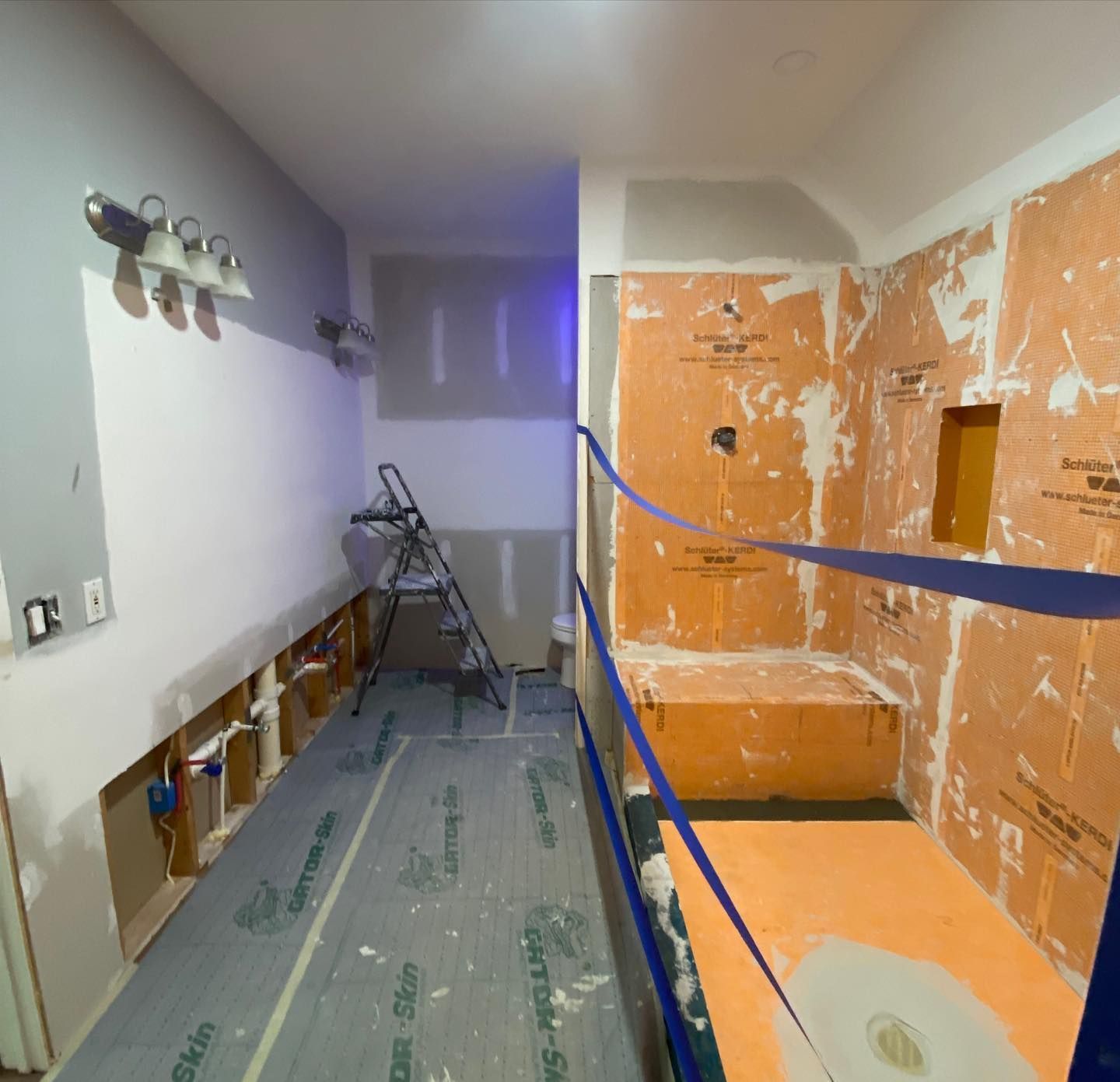 A bathroom that is being remodeled with a bathtub and a ladder