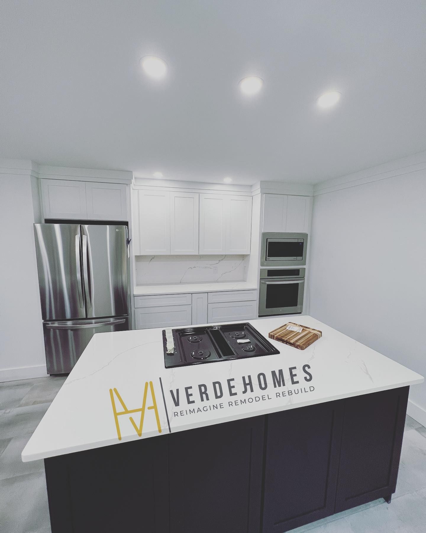 A kitchen with a large island that says verde homes on it