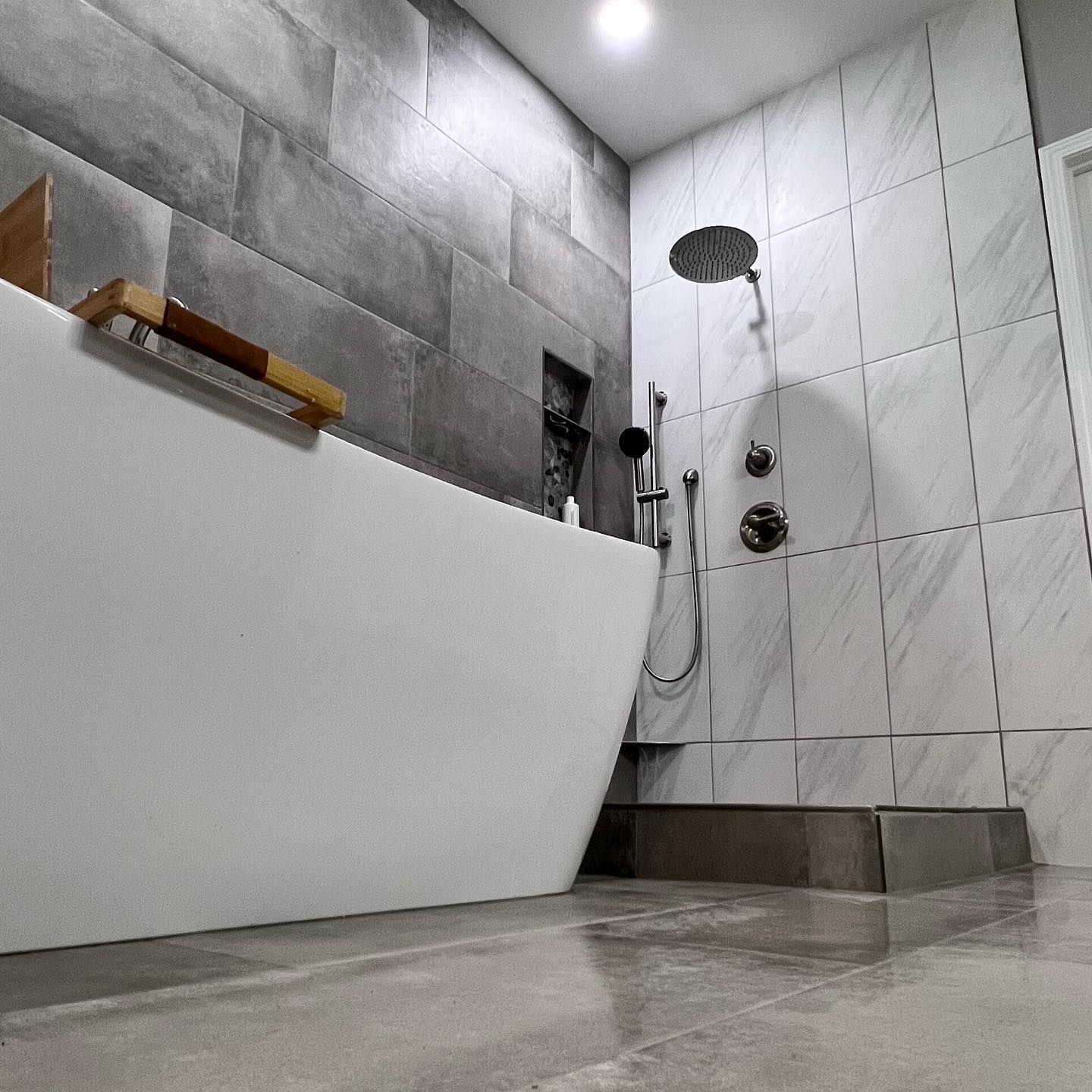 A bathroom with a bathtub and a shower.