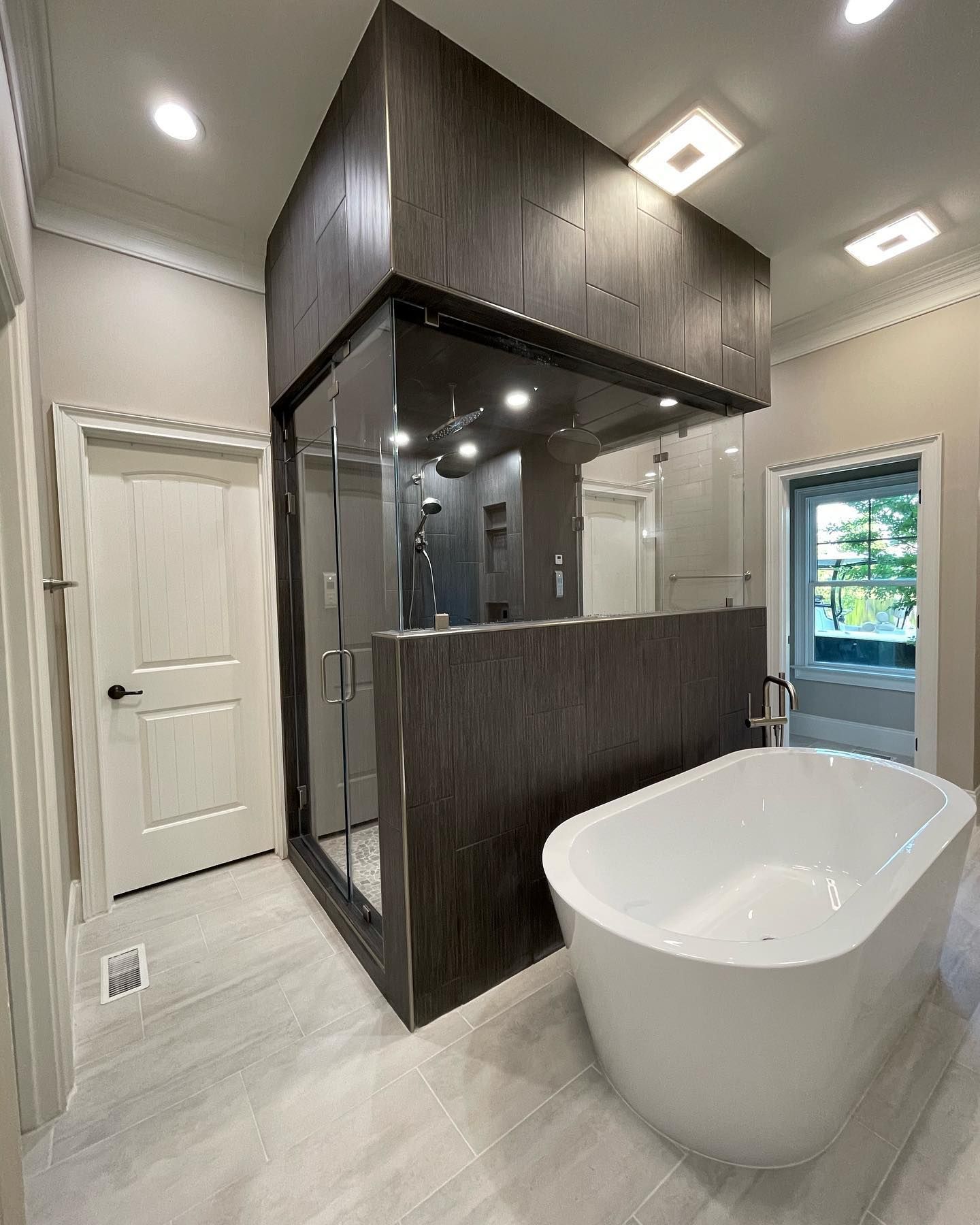 There is a bathtub in the middle of the bathroom.