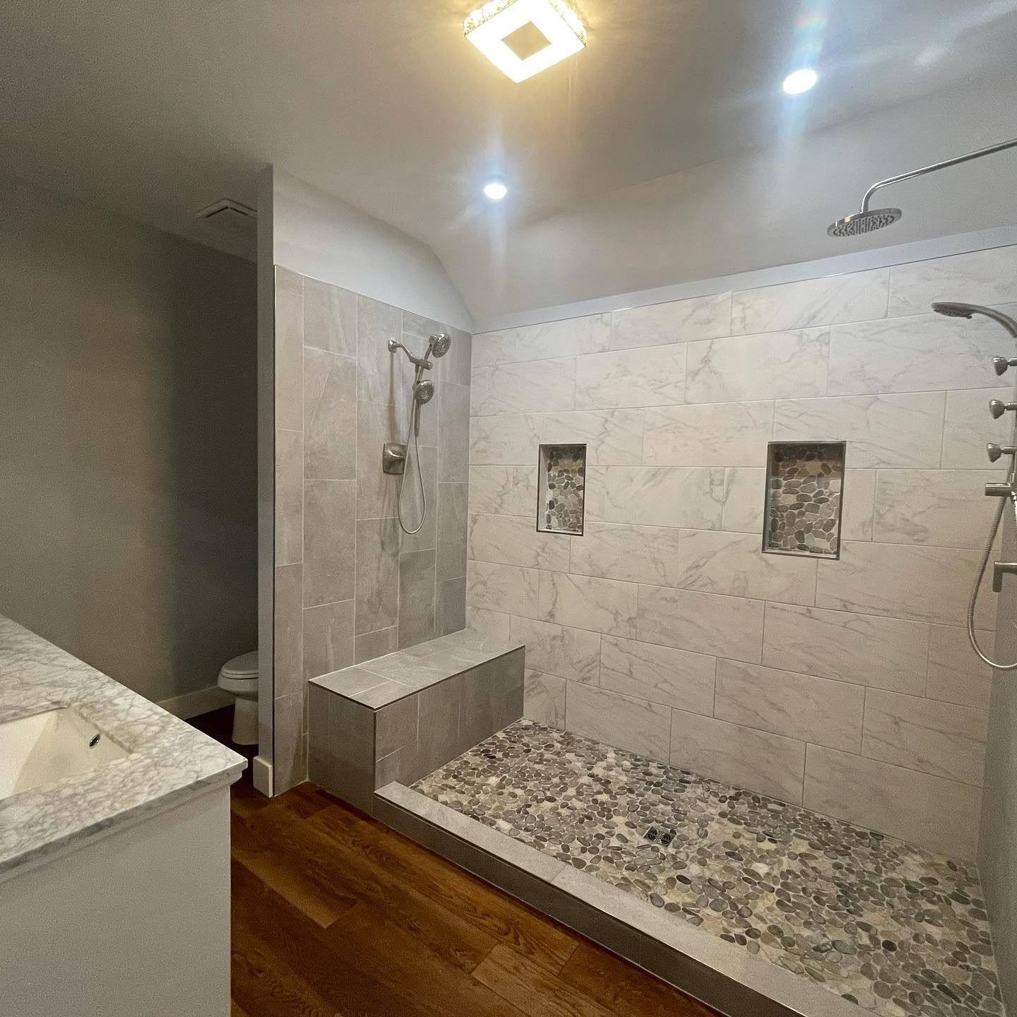 A bathroom with a walk in shower and a toilet.