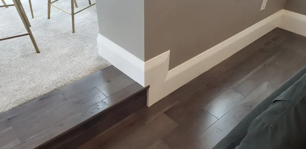 A living room with hardwood floors and a couch.