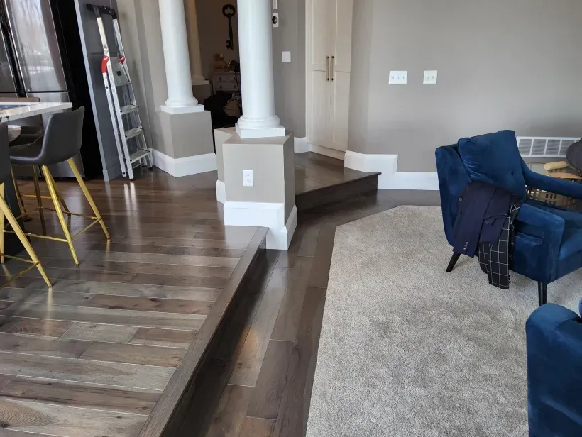 A living room with hardwood floors and a blue chair.