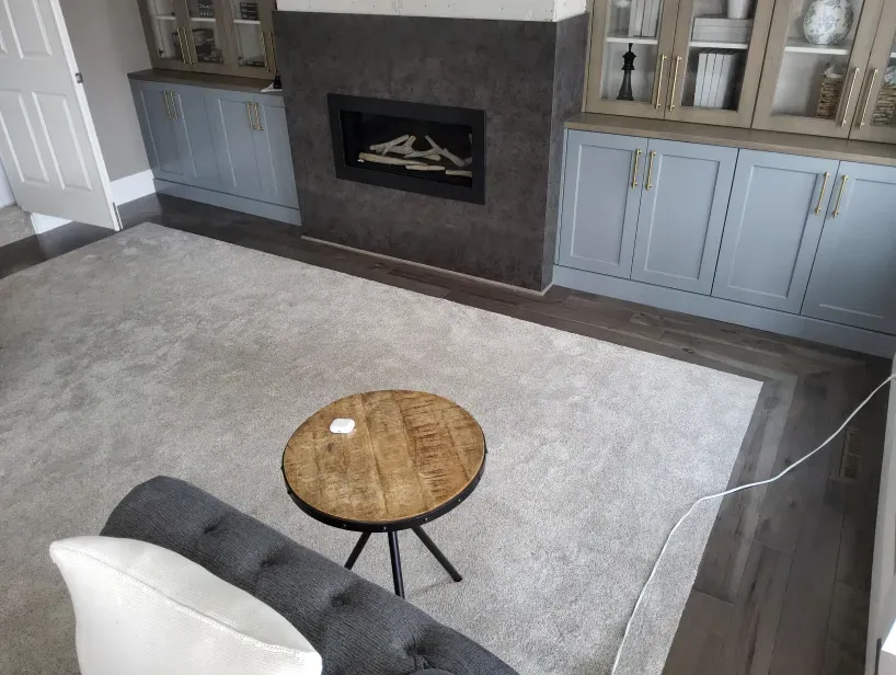 A living room with a fireplace , couch , table and rug.