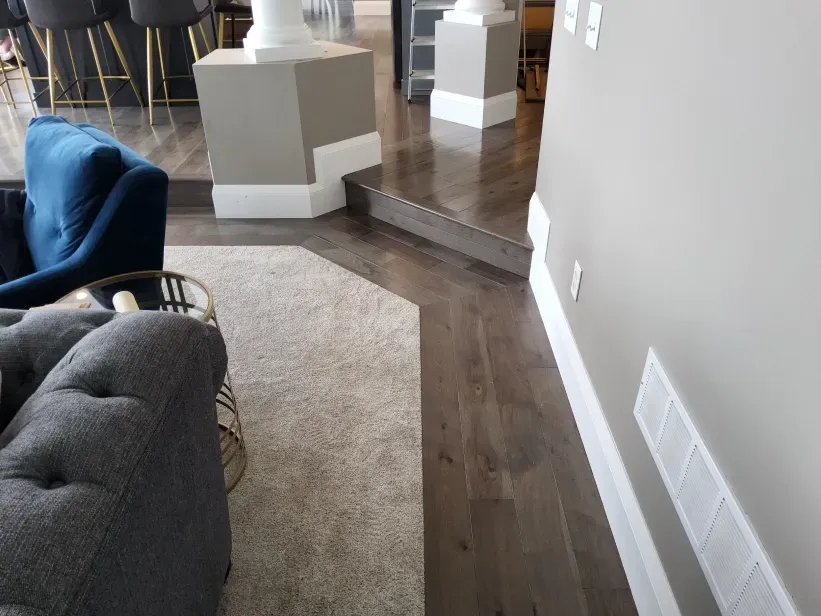 A living room with hardwood floors and a blue chair