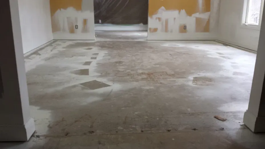 A room with a concrete floor and white walls.