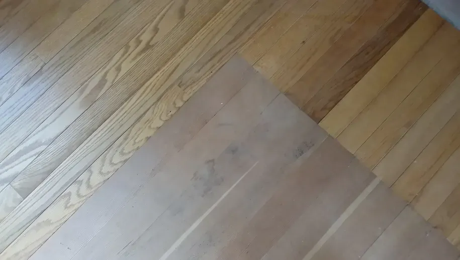 A close up of a wooden floor with two different types of wood.