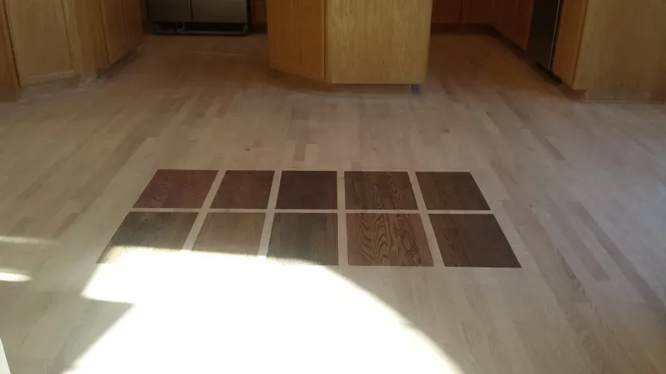 A kitchen with a wooden floor and a grid of squares on it.