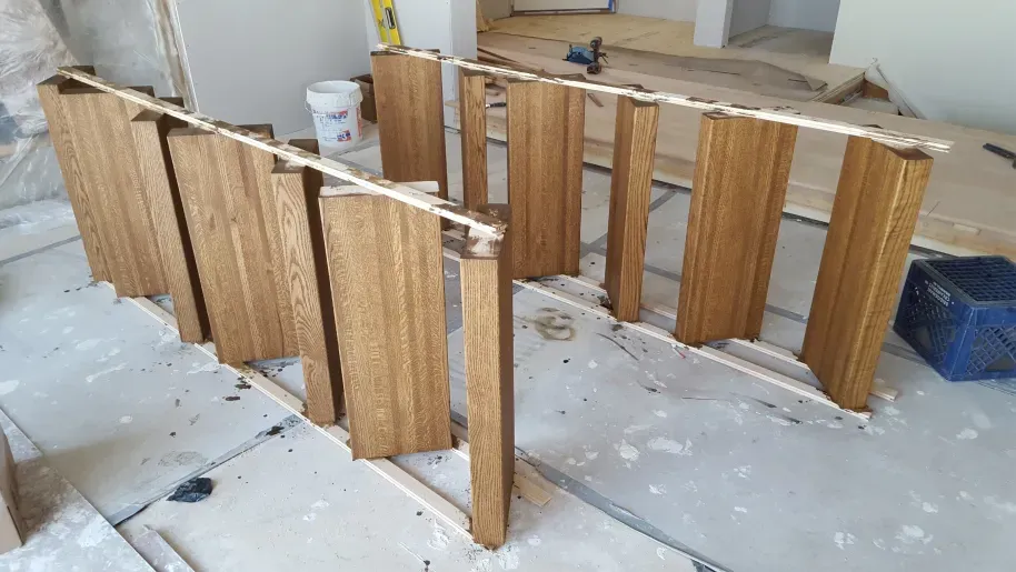 A bunch of wooden boards are sitting on the floor in a room.