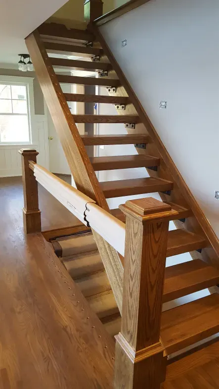 A wooden staircase leading up to the second floor of a house.