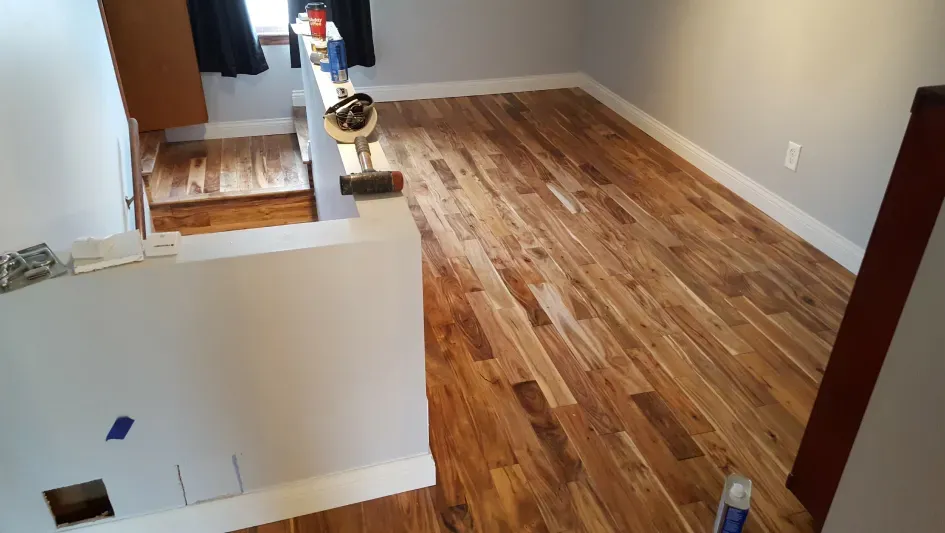 A room with hardwood floors and a window.