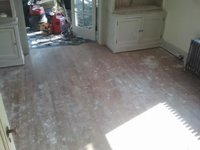 A room with a wooden floor and a radiator