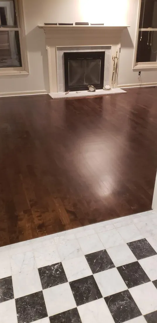 A living room with a fireplace and a checkered floor.