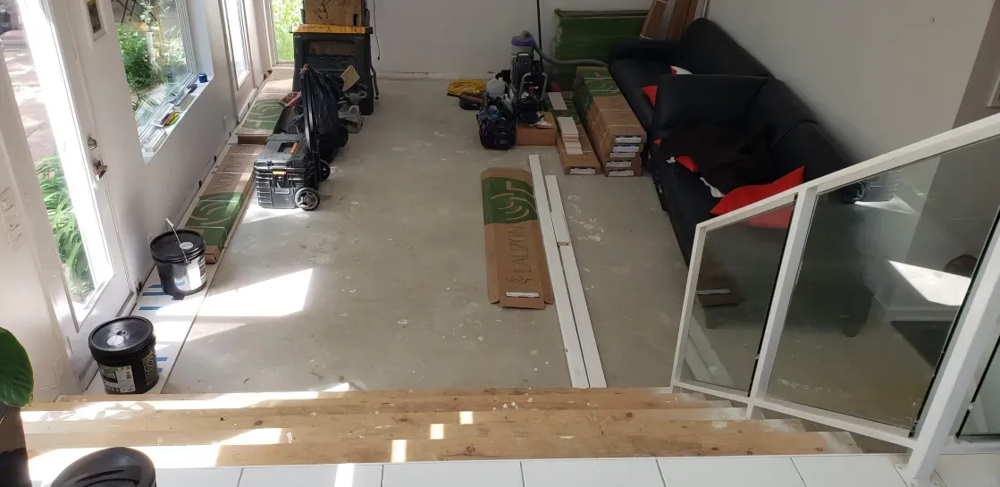 An aerial view of a living room with a couch and stairs.