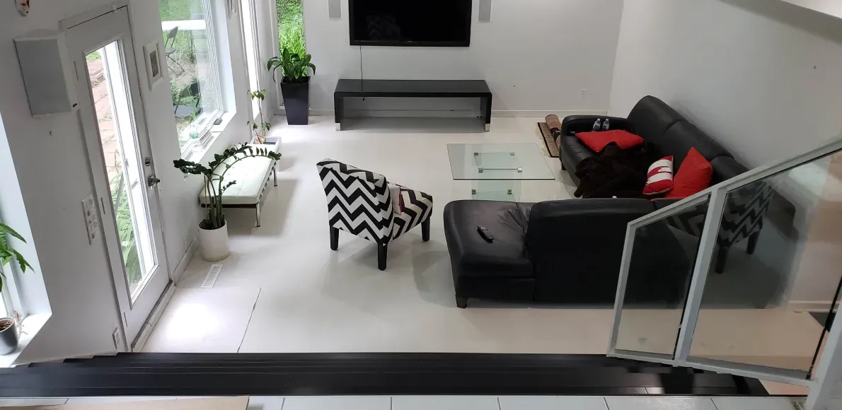 An aerial view of a living room with a couch and chairs